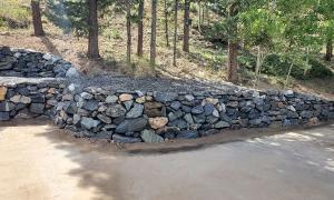 After photo of a sloped yard with a retaining wall. 