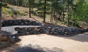 After photo of a sloped yard with a retaining wall. 