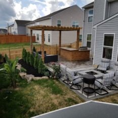 backyard featuring pinetrees,chairs and luncrete
